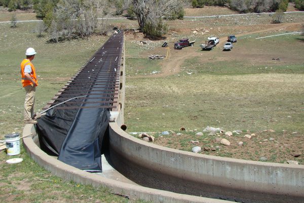 Staff oversees installation of liner in 450 foot flume.