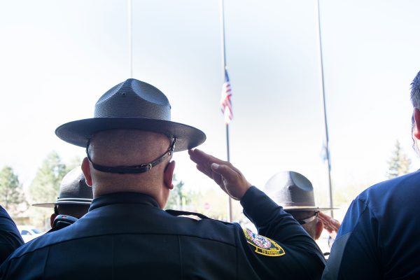 image of officer saluting the american flag