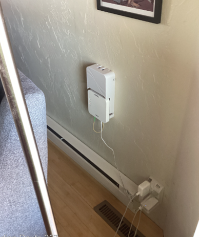 Photo of internet fiber equipment on wall in residential interior.